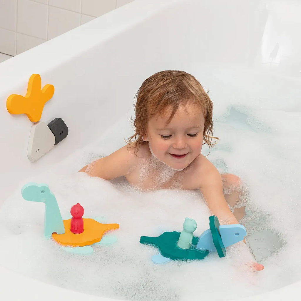 Toddler assembling Puzzle Friends Dino World dinosaurs in the bath