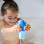 Toddler floating Squeezi Hippo in a small pool