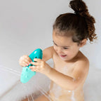 Toddler enjoying imaginative water play with Squeezi Croco