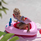 Child pretending to sail in a playful inflatable boat toy