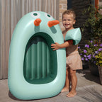 Kids splashing and playing together with an inflatable pool boat