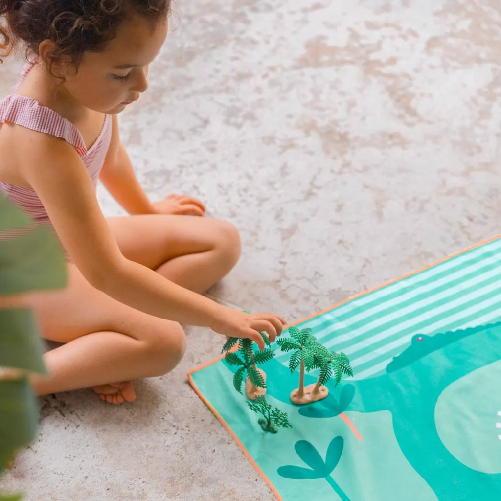 Kids using a lightweight safari play towel for beach and pool fun