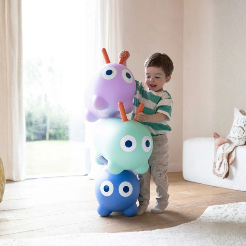 Toddlers hopping and bouncing on a colorful inflatable bouncy toy during playtime