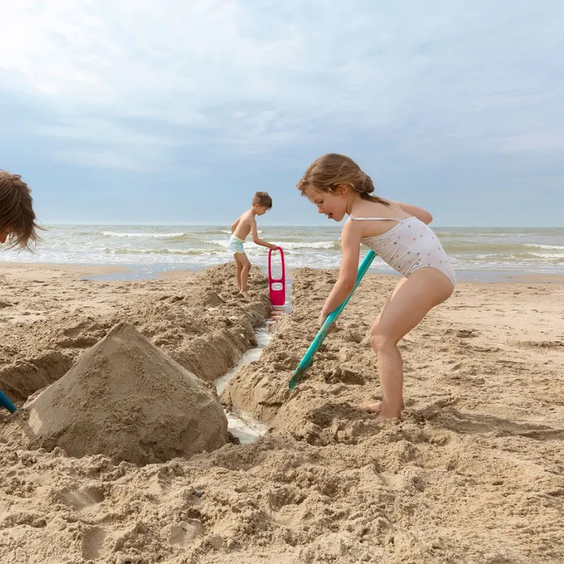 Kids digging, scooping, and exploring on the beach with Scoppi shovel toy
