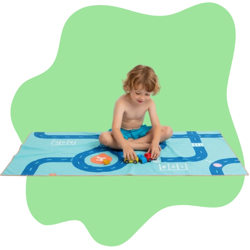 Kids using a road-pattern towel for creative storytelling play
