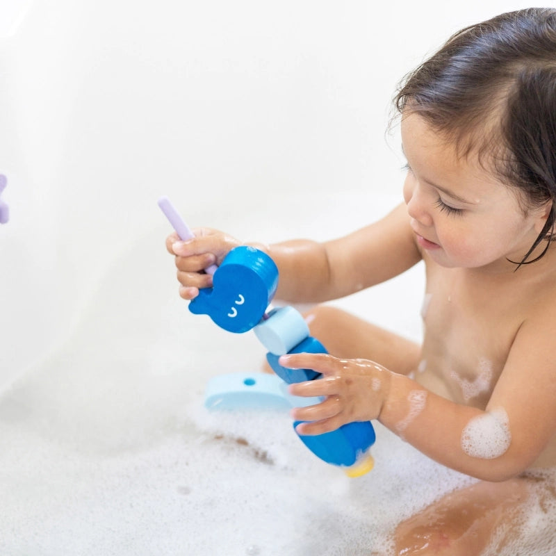 Beedi Hippo in action with toddlers floating, sticking, and lacing foam beads during bath play