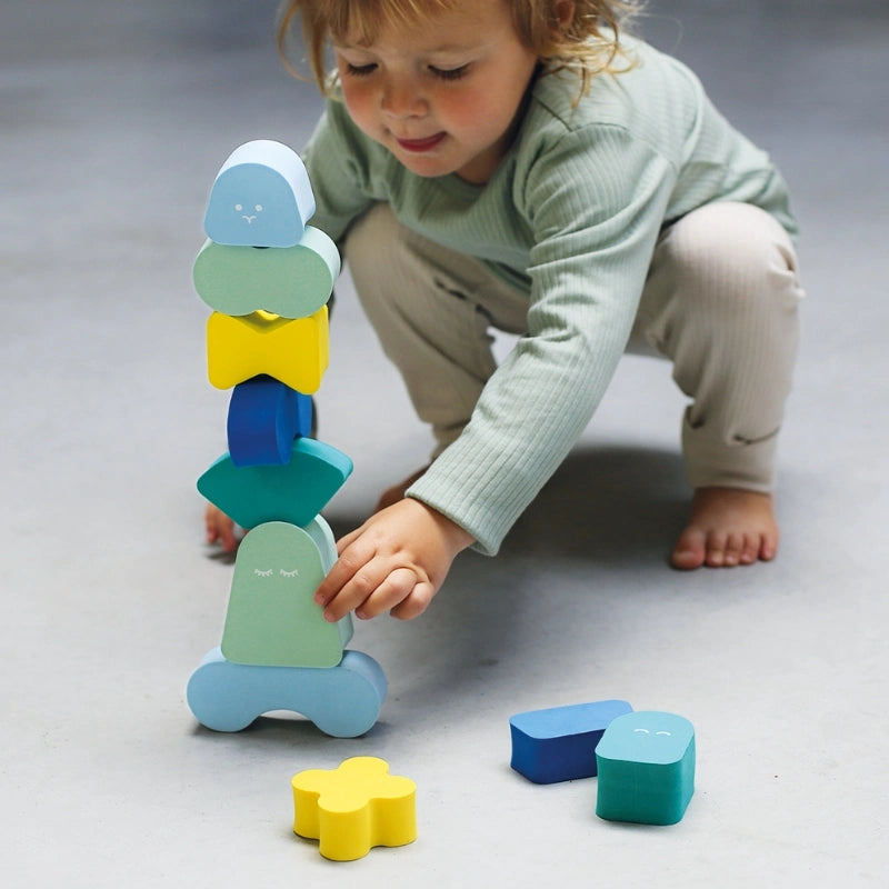 Toddlers stacking and balancing Blokki foam blocks during creative indoor play