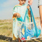 Toddler using Raki rake and shovel to dig and build sand structures