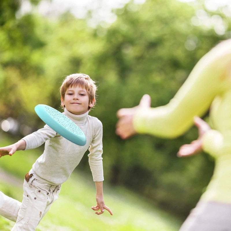 Kids having fun throwing and sifting with the Flying Disc outdoors