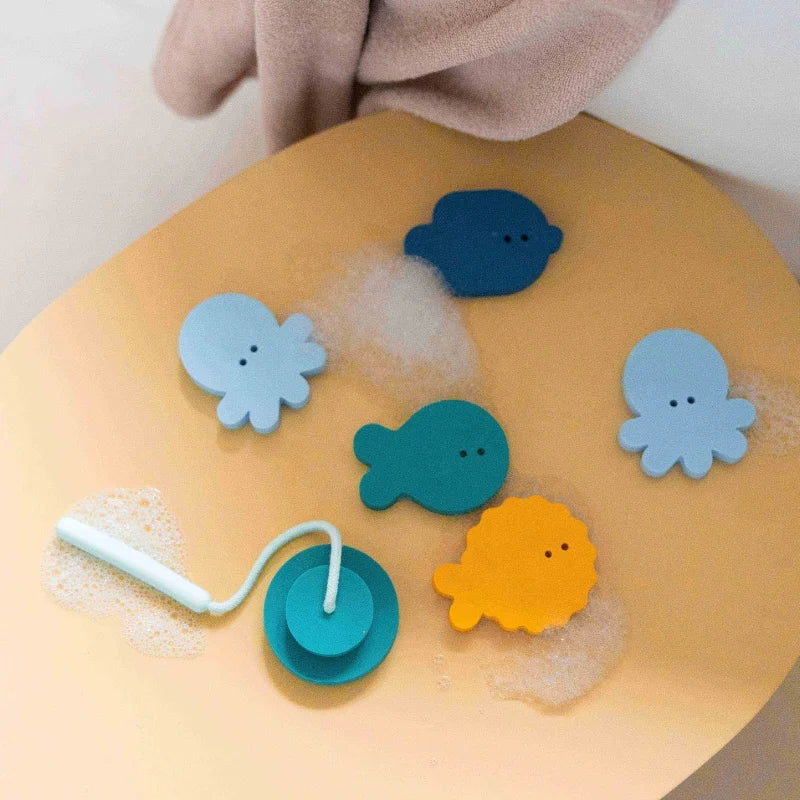 Toddler fishing and sticking foam fish in bath with Fishing Deepsea set