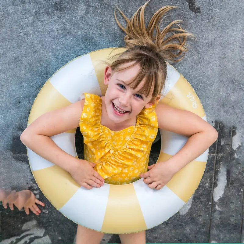 Toddler enjoying colorful Swimring during pool or beach play