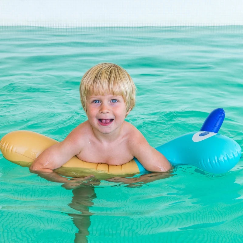 Toddlers riding and floating on Noodle Giraffe for land and pool adventures, promoting active, safe, and imaginative play