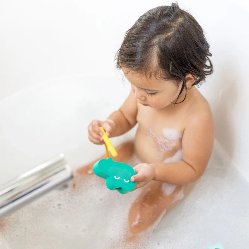 Toddler lacing Beedi Croco foam beads during bath time play