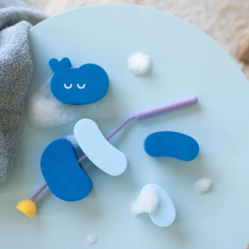 Playing with Beedi Hippo floating foam beads during bath time