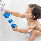 Kids sticking Beedi Hippo EVA foam beads to bathroom wall