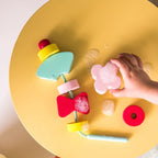 Toddler playing with Beedi Shapes floating foam beads during bath time