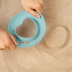 Children stacking and using Magic Shapers for creative outdoor play