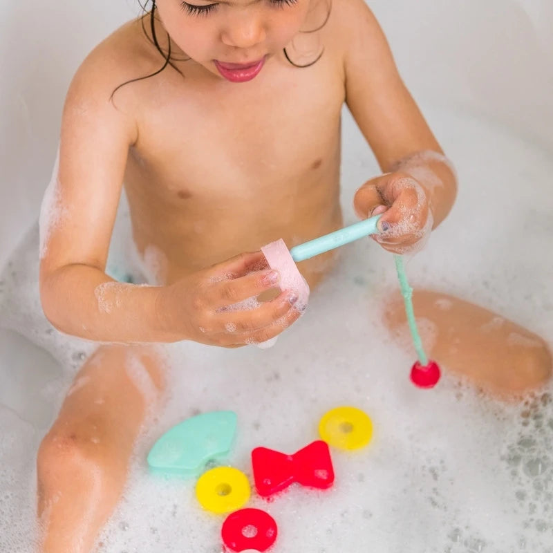 Child lacing Beedi Shapes beads to develop fine motor skills