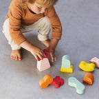 Kids building towers with soft foam blocks during indoor play