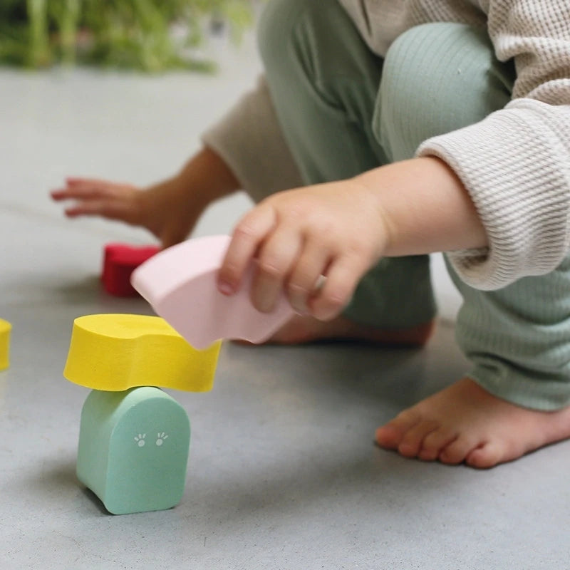 Toddler stacking Blokki foam blocks to practice balance and coordination