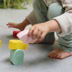 Toddler stacking Blokki foam blocks to practice balance and coordination