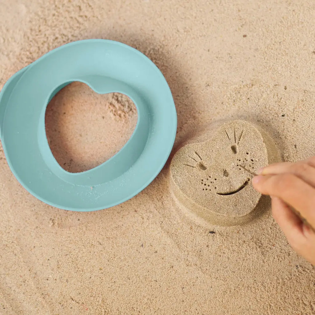 Kids using Magic Shapers molds with kinetic sand and clay