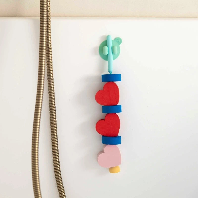 Kids sticking Beedi Hearts EVA foam beads to bathroom wall