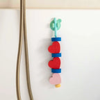 Kids sticking Beedi Hearts EVA foam beads to bathroom wall
