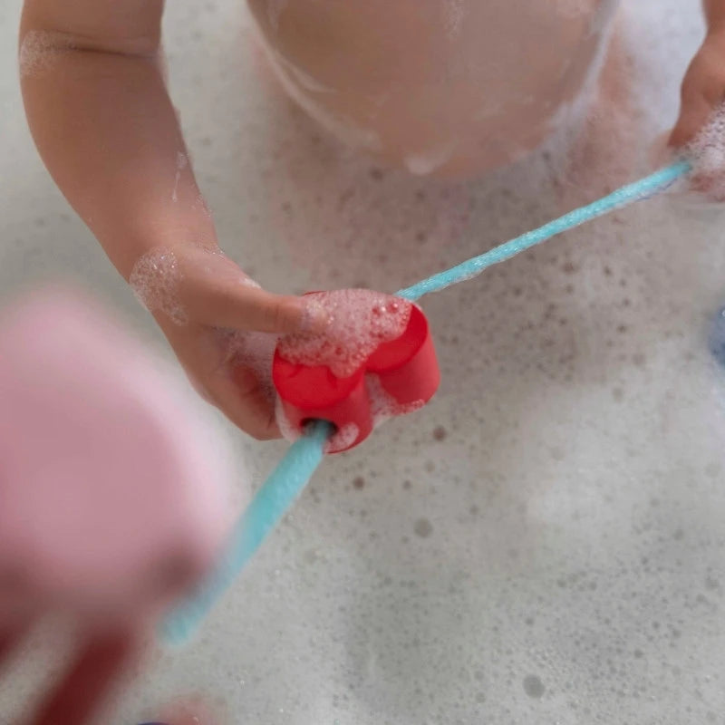 Kids enjoying creative bath play with Beedi Hearts heart-shaped beads