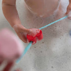 Kids enjoying creative bath play with Beedi Hearts heart-shaped beads