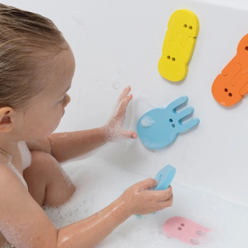 Child enjoying imaginative water play with jellyfish foam shapes