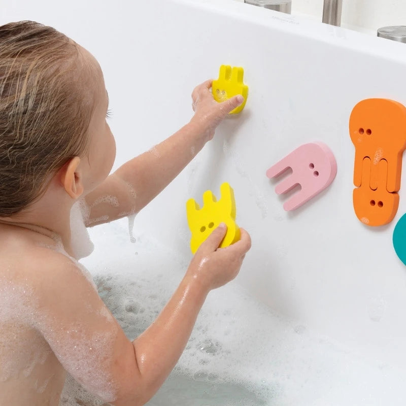 Toddler developing fine motor skills with floating bath puzzle toys