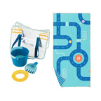 Children's playset with clear bag, blue bucket, yellow shovel, and towel with road map design on a white background.