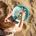 Child tossing the vintage blue disc for active play