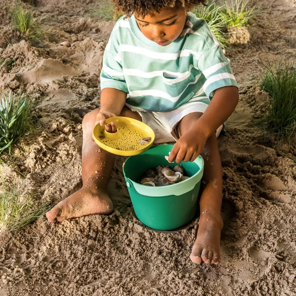 Kids using Bucki bucket and detachable sieve to gather seashells and treasures
