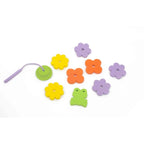 Toddler fishing floating foam frogs from bathtub with soft rod