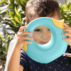 Child spraying water with banana blue Cana Watering Can at the garden