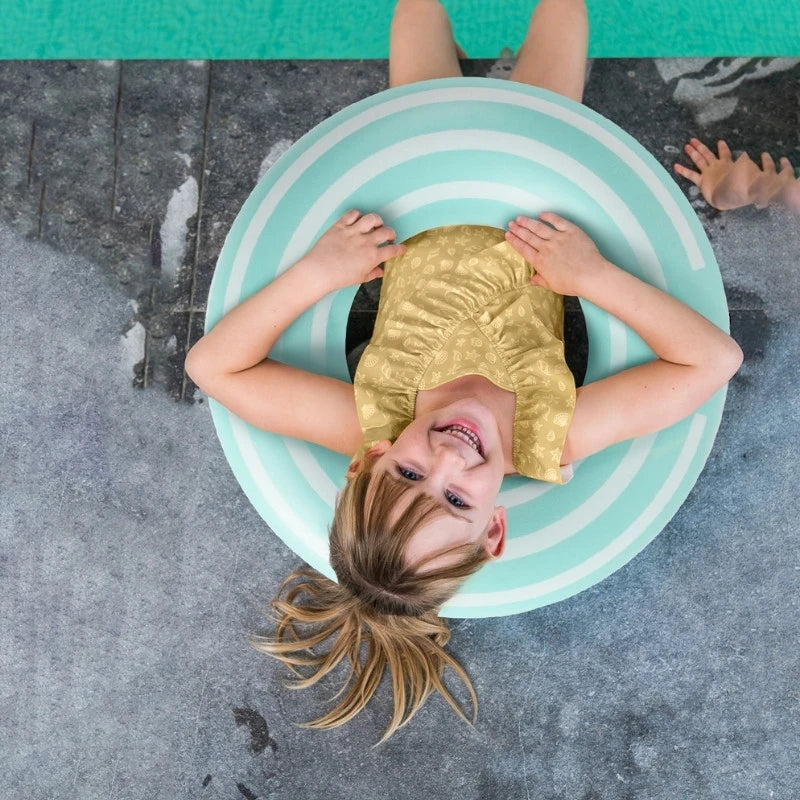 Poolside play with toddler and colorful inflatable Swimring