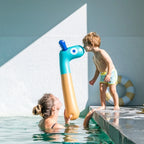 Kids playing together using Noodle Giraffe for imaginative adventures