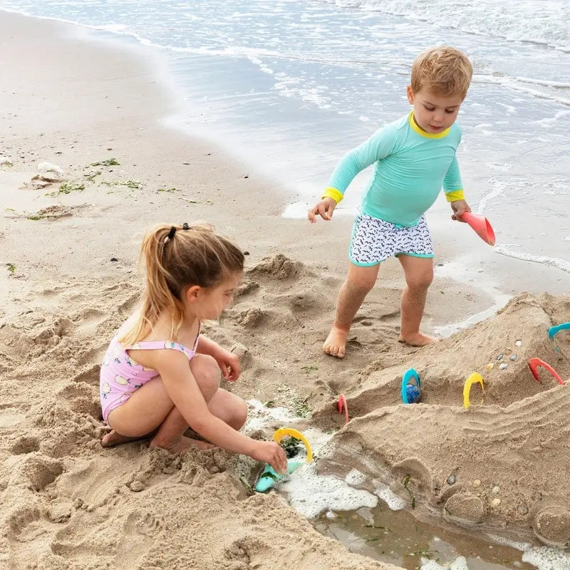 Kids using Magic Shaper to build sandcastles together