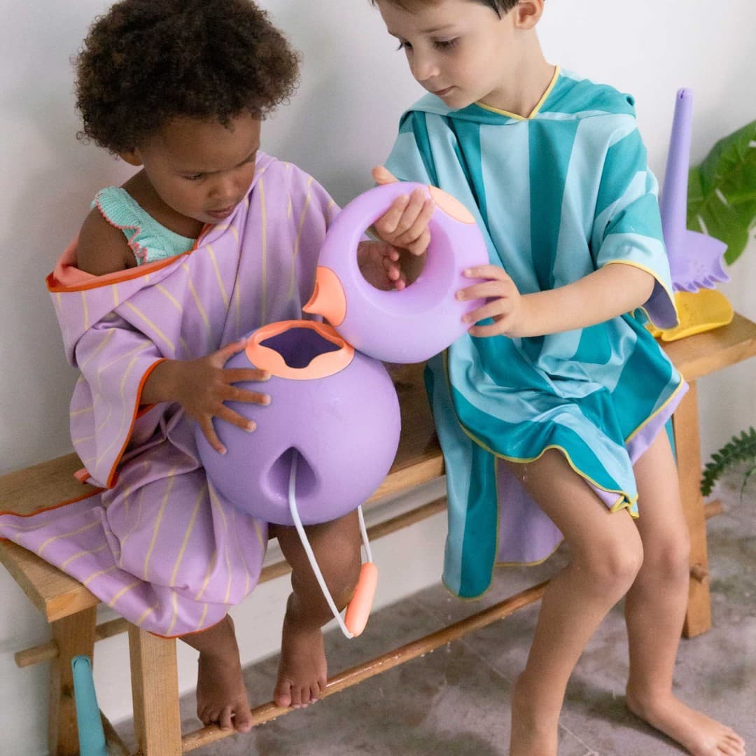 Children enjoying dual-function water play with Cana Watering Can indoors and outdoors