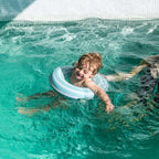 Toddler learning balance using inflatable Swimring