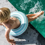 Pool play with toddler holding onto Swimring
