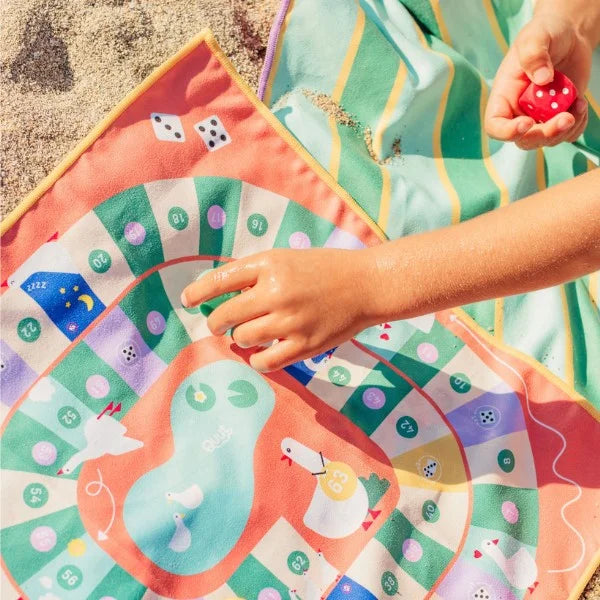 Young child strategizing moves while playing Snakes & Ladders