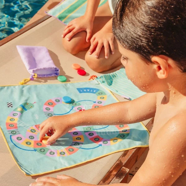 Two children taking turns with the double-sided Quut travel game