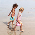 Toddler holding Cana while walking on the beach