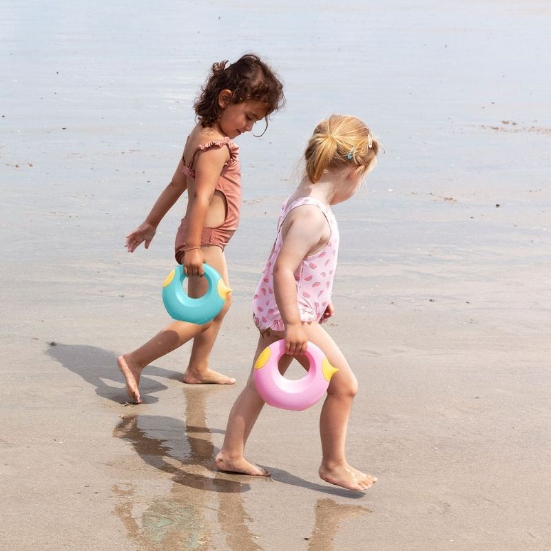 Toddler holding Cana while walking on the beach