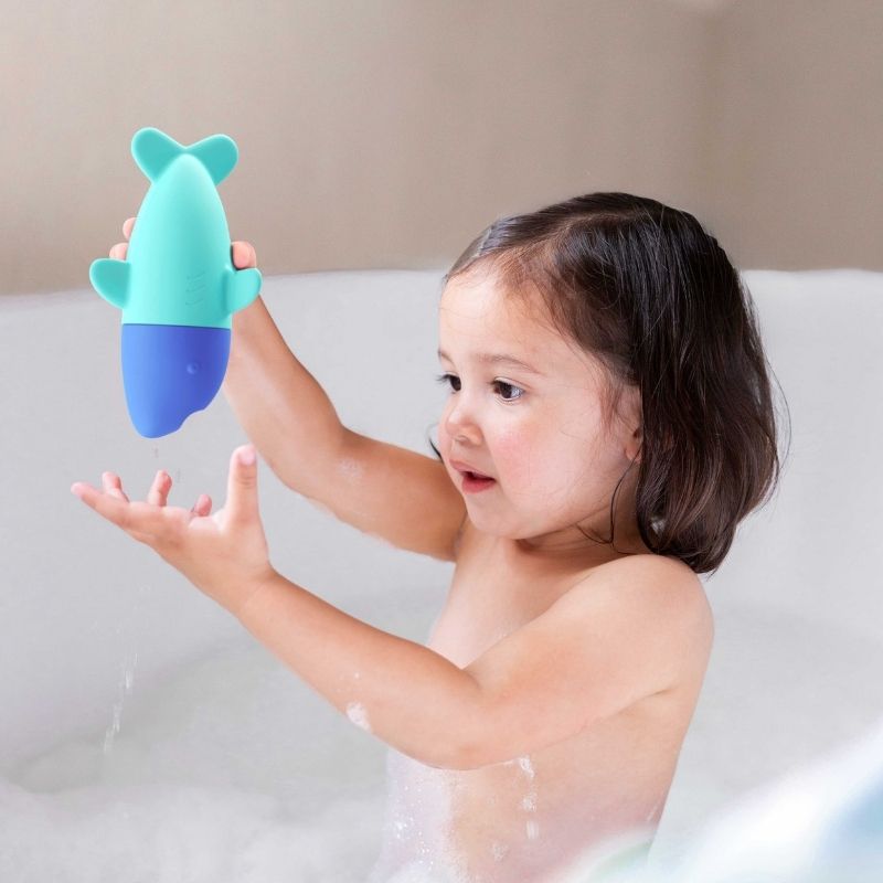 Child squeezing the soft silicone Squeezi Shark in the bathtub
