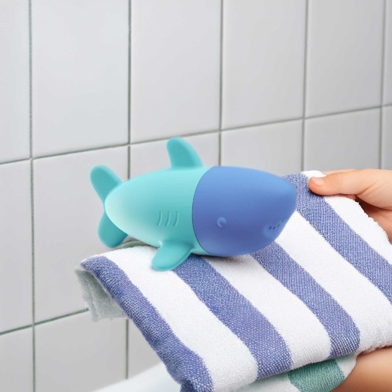 Toddler exploring water play with the Squeezi Shark