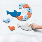 Child assembling shark puzzle pieces during bath time